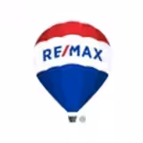 A hot air balloon with a red top, white middle, and blue bottom, featuring the text RE/MAX in blue and red letters across the white band.